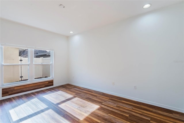 unfurnished room with dark hardwood / wood-style floors