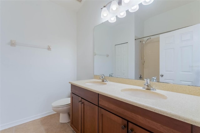 bathroom with tile patterned flooring, vanity, a shower, and toilet