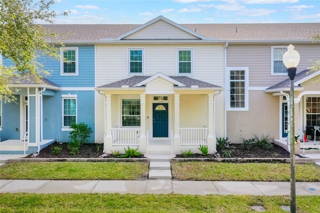 13730 Lensdale Ln, Windermere, FL 34786 - townhome / multi-family property featuring a porch, stucco siding, and a shingled roof