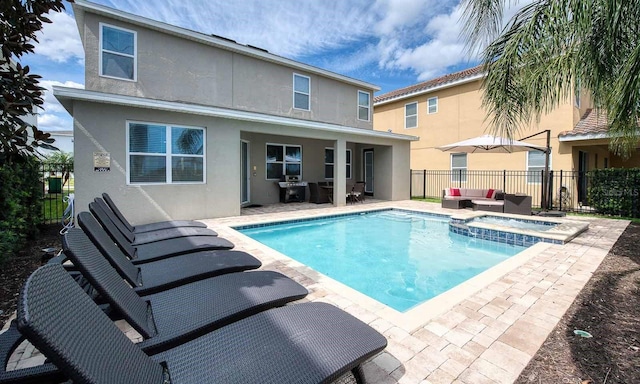 view of pool with grilling area, an outdoor hangout area, and a patio