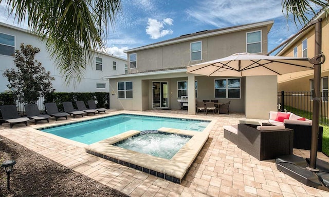 view of swimming pool with an in ground hot tub, an outdoor hangout area, and a patio