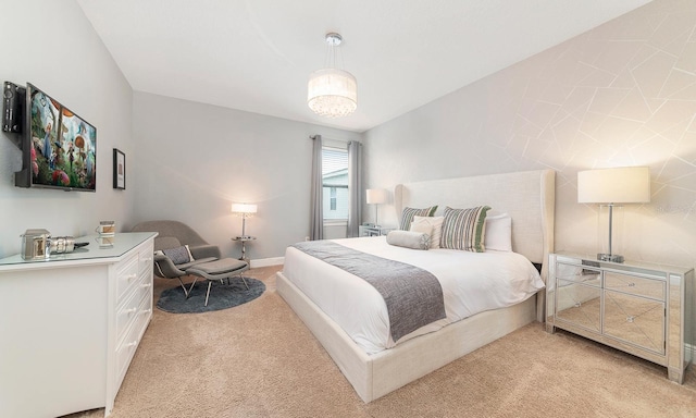 carpeted bedroom with an inviting chandelier