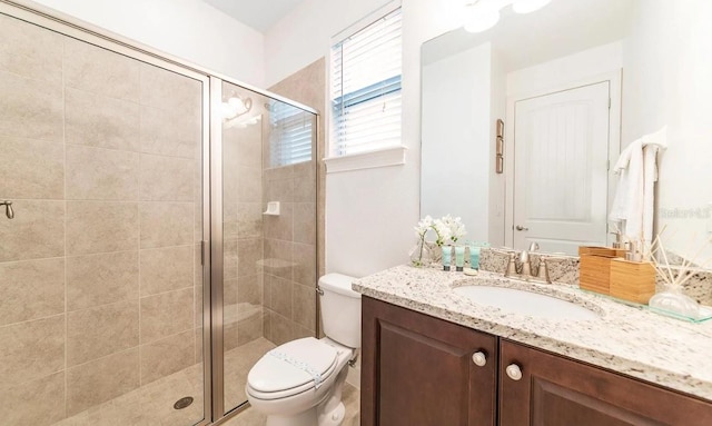 bathroom featuring vanity, toilet, and walk in shower