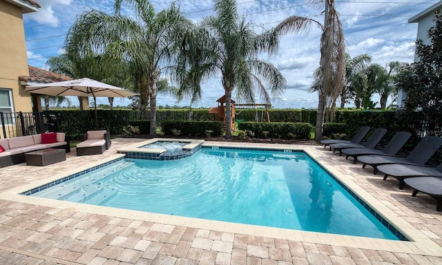 view of swimming pool with an outdoor hangout area, a patio, and an in ground hot tub