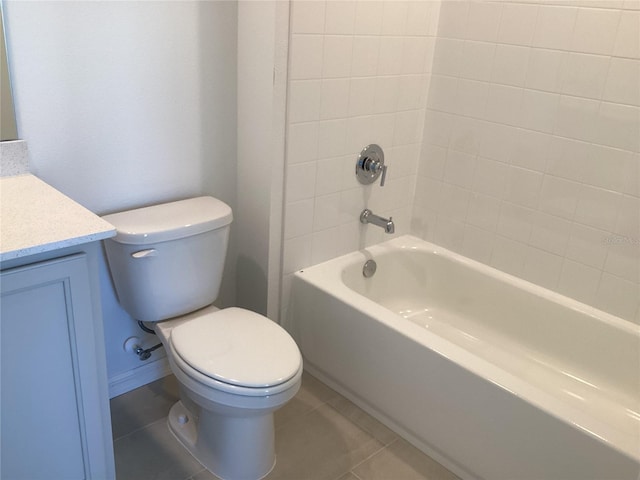 full bath with toilet, washtub / shower combination, vanity, and tile patterned floors