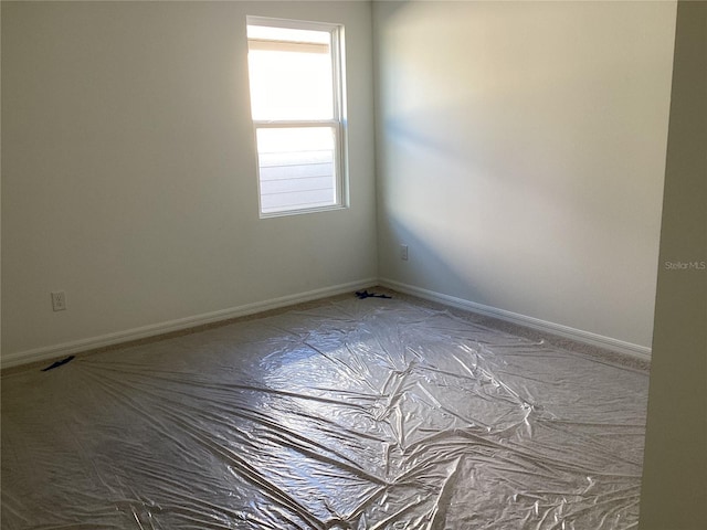 unfurnished room featuring baseboards