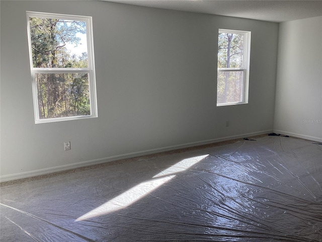 spare room featuring baseboards