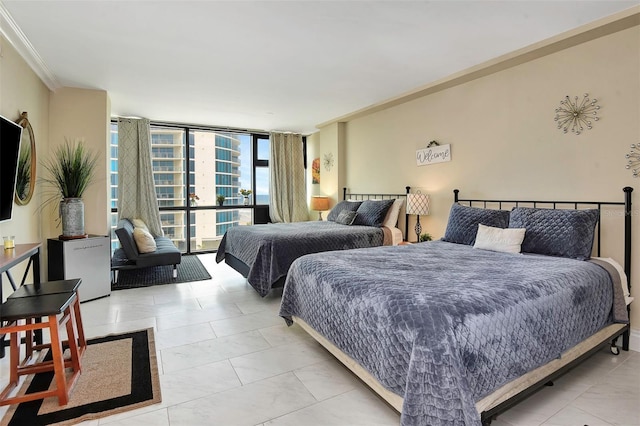 bedroom with ornamental molding and expansive windows