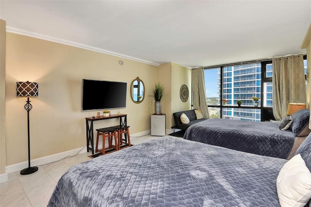 bedroom featuring expansive windows and crown molding