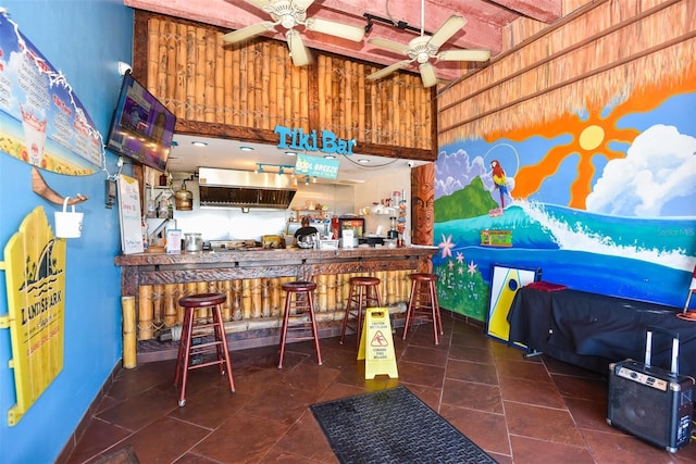 bar featuring a towering ceiling and ceiling fan