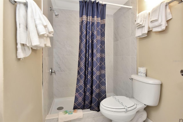 bathroom featuring curtained shower and toilet