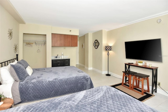 tiled bedroom with bar area and a closet