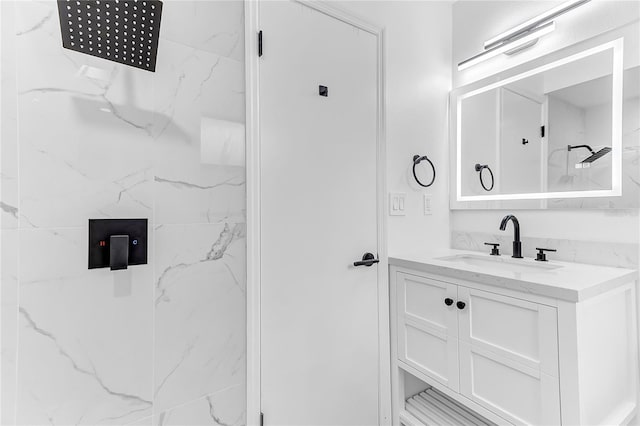 bathroom with vanity and a tile shower