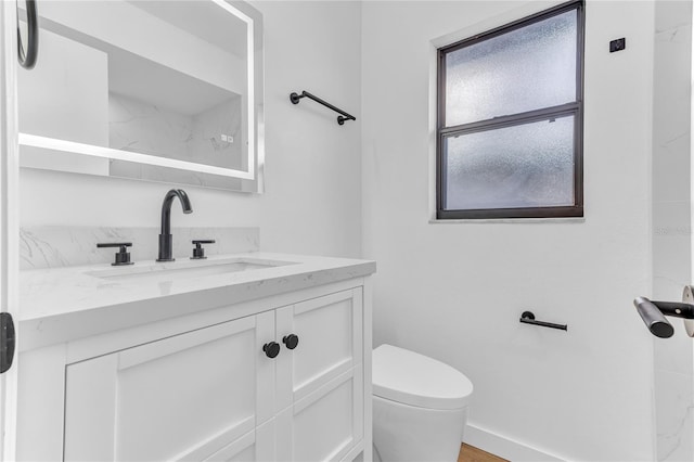 bathroom featuring vanity and toilet