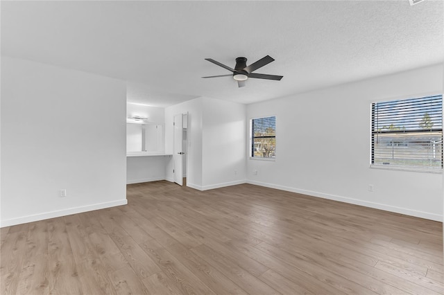 unfurnished living room featuring light wood-type flooring, a textured ceiling, and ceiling fan