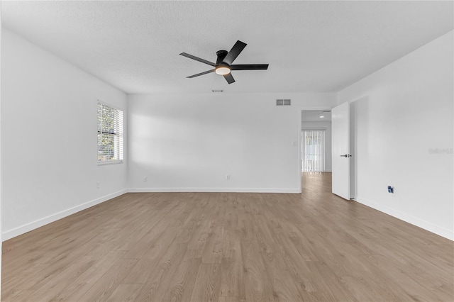 unfurnished room featuring ceiling fan, a textured ceiling, and light hardwood / wood-style floors