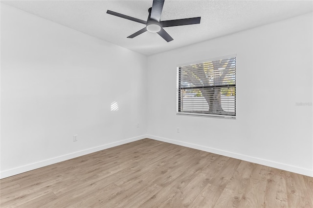 spare room with ceiling fan, light hardwood / wood-style flooring, and a textured ceiling