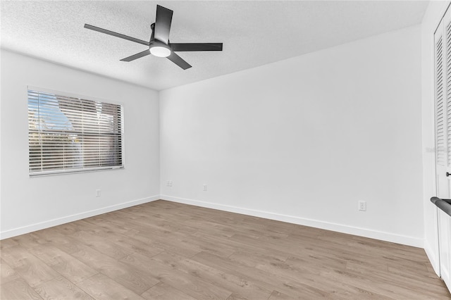 unfurnished room featuring ceiling fan, light hardwood / wood-style flooring, and a textured ceiling