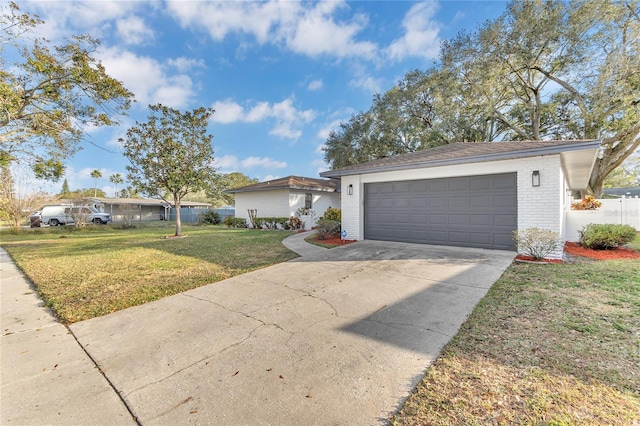 single story home with a garage and a front yard