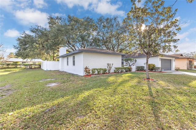 view of front of house with a garage and a front lawn