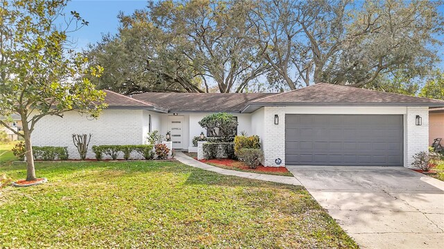 single story home featuring a garage and a front yard