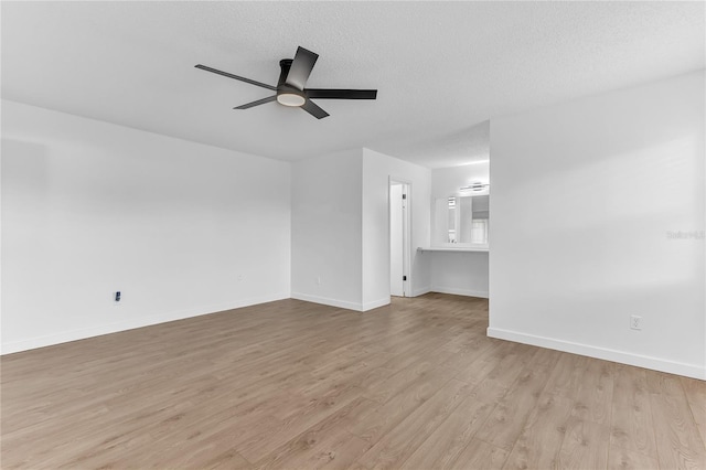 unfurnished living room featuring ceiling fan, light hardwood / wood-style flooring, and a textured ceiling