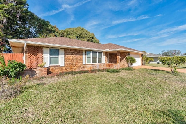 ranch-style home featuring a garage and a front lawn