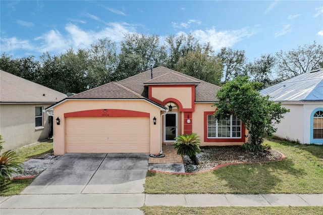 view of front of property with a garage and a front yard