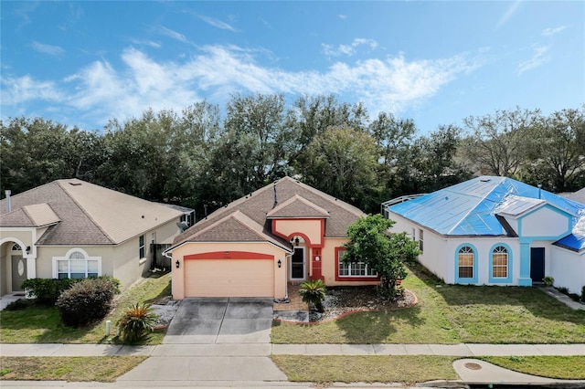 view of front facade featuring a garage and a front lawn