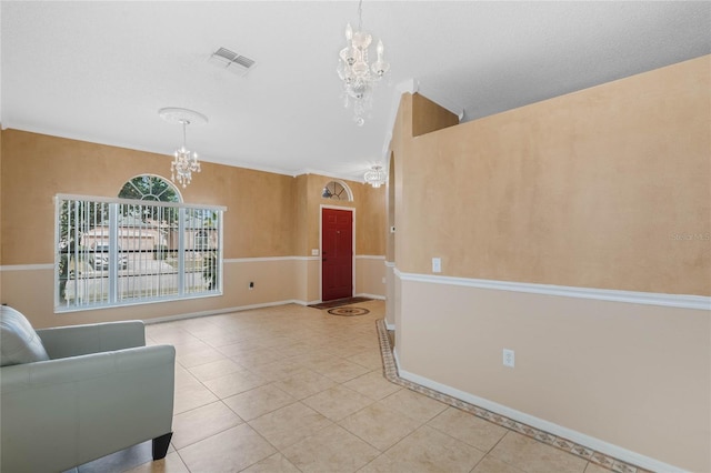 unfurnished room featuring a notable chandelier and light tile patterned floors