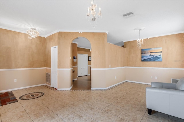 interior space featuring crown molding, tile patterned floors, and a notable chandelier