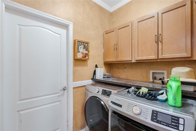 laundry area featuring cabinets, ornamental molding, and washing machine and dryer