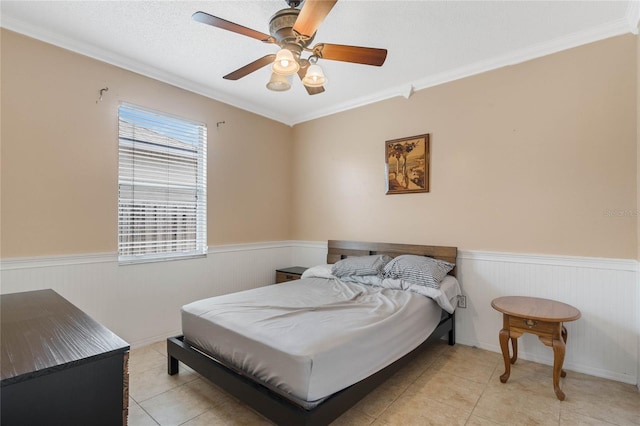 bedroom with ceiling fan, ornamental molding, a textured ceiling, and light tile patterned flooring