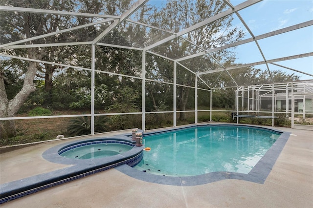 view of swimming pool featuring an in ground hot tub, a lanai, and a patio