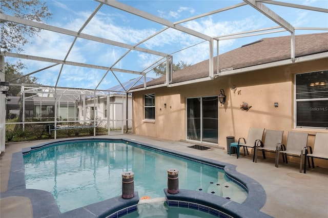 view of swimming pool featuring an in ground hot tub, a lanai, and a patio area