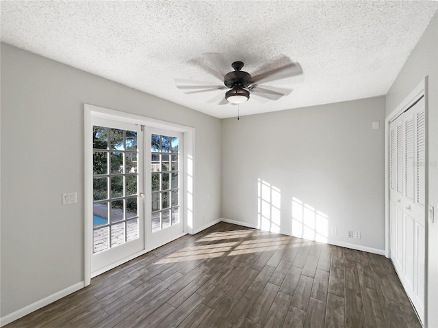 unfurnished room featuring dark hardwood / wood-style flooring, a textured ceiling, french doors, and ceiling fan