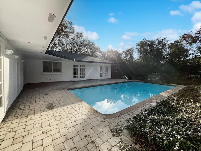 view of pool featuring french doors and a patio area