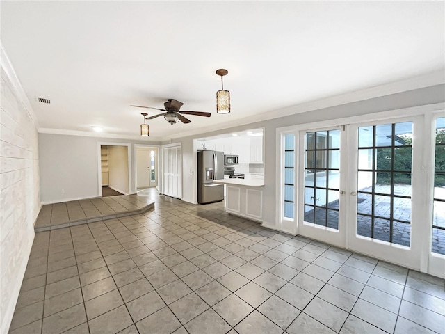 unfurnished living room with crown molding, light tile patterned floors, and ceiling fan