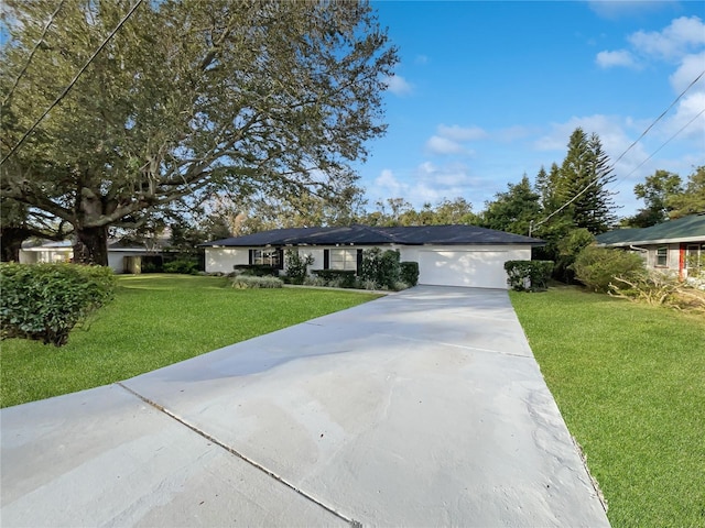 ranch-style house with a garage and a front yard