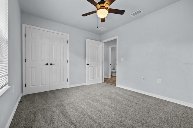 unfurnished bedroom featuring ceiling fan, a closet, and carpet