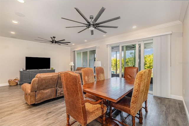 dining area with ceiling fan, ornamental molding, and light wood-type flooring