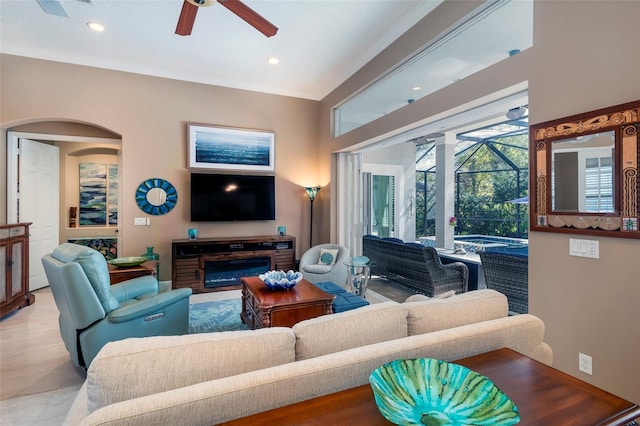 living room with ceiling fan and ornamental molding