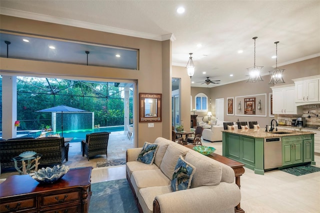 living room featuring ornamental molding, sink, and ceiling fan