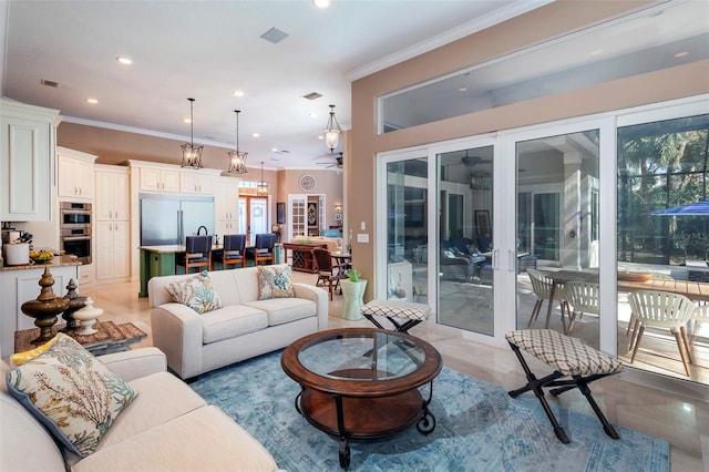 living room with ceiling fan and ornamental molding