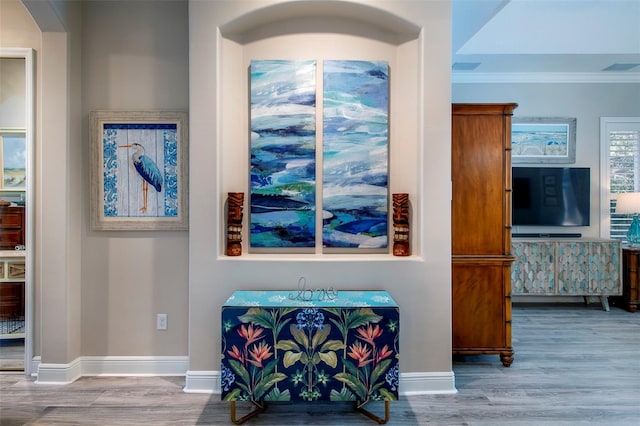 interior details with wood-type flooring and ornamental molding