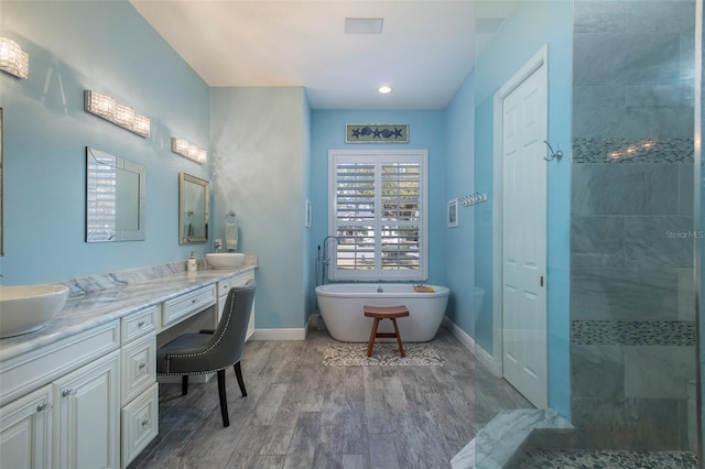 bathroom featuring vanity, hardwood / wood-style flooring, and shower with separate bathtub