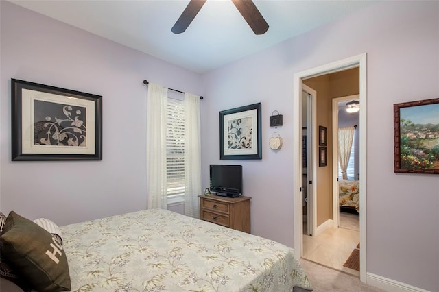 bedroom with light carpet and ceiling fan