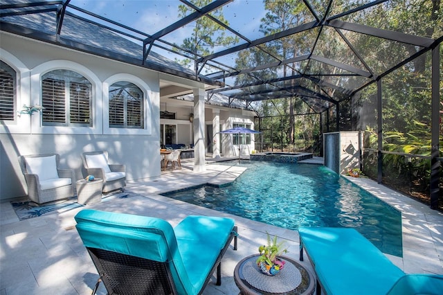 view of pool featuring an outdoor living space, a patio, ceiling fan, and glass enclosure