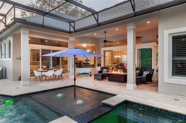 view of patio featuring an outdoor living space, ceiling fan, and glass enclosure