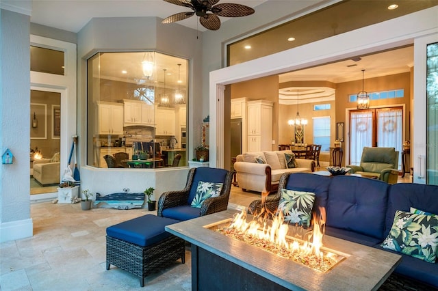 interior space featuring ceiling fan with notable chandelier